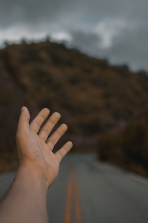 Opened hand with a mountain at the background