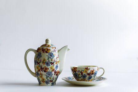Colorful teapot and cup on a white backgroundの写真素材