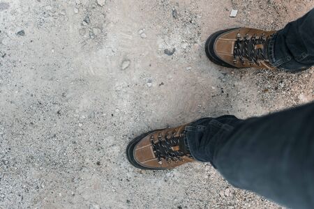 Boots top view of man walking on pathの写真素材