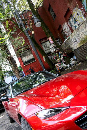 Mexico city, Mexico ; 10 30 2018: Expensive car and homeless in the background. Showing the social hierarchies and social class.のeditorial素材