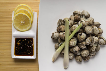 Delicious boiled fresh cockles served with spicy & delicious seafood sauce with lemon and lemon...