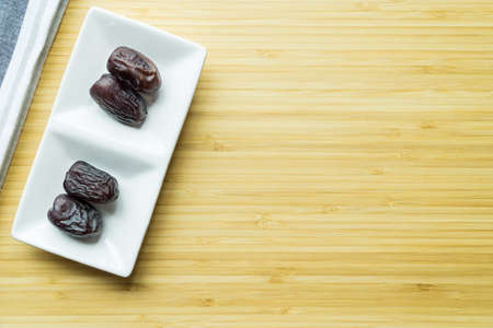 Kurma or dates on wooden boardの写真素材