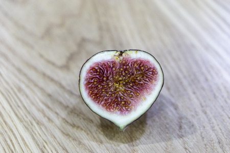 Fresh raw ripe figs on wooden background.の写真素材