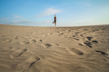 desert view and ypga pose at parangkusumo jogjakarta indonesiaの写真素材