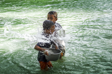 two kids enjoyed playing water at the riverのeditorial素材