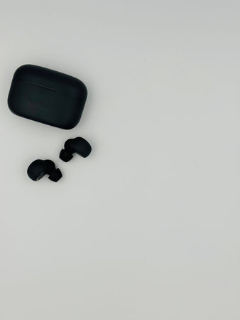 Black earphones on a white background, top view, copy space. Place for text.の写真素材