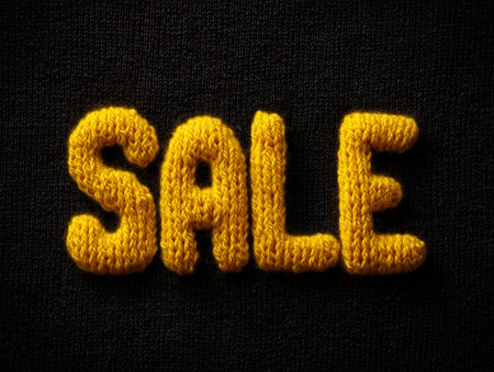 Sale word on black fabric background. Seasonal offer concept.の素材