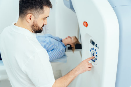 Male medical professional helping mature woman in CT scanner.の写真素材