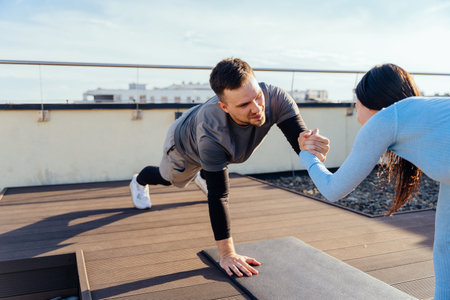 Support, trust, teamwork and fitness concept. Sportive woman and man holding hands while standing in...