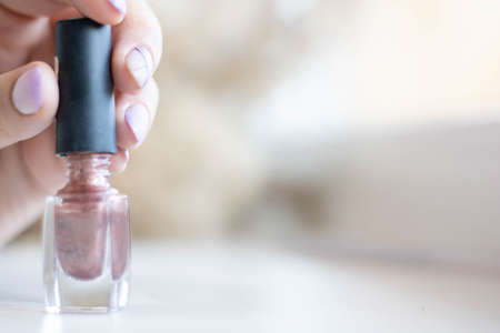 girl paints her nails. nail polish manicure on white backgroundの写真素材