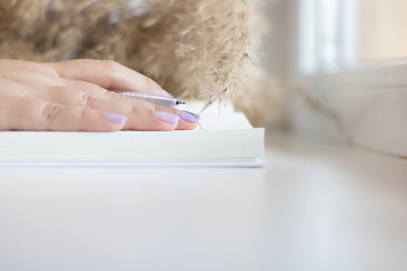person writing on a notebook