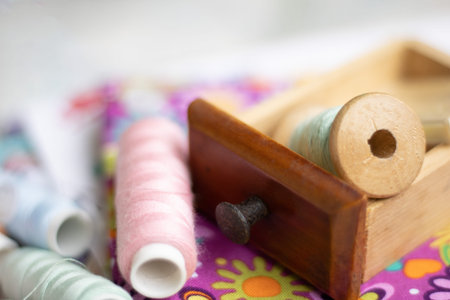 Spools of thread in a wooden box. Selective focus.