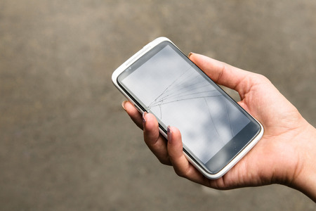 broken phone in the handの写真素材