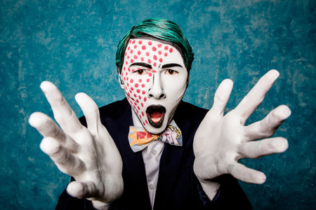 man mime expresses delight with hands. dressed in the style of pop art. bright makeupの写真素材
