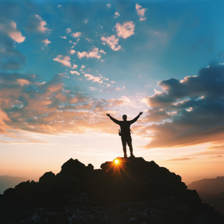 successful man on top of the mountain reaches for the sun. success conceptの素材
