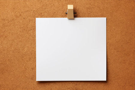 Blank white paper on wood background with clip for your design.の素材
