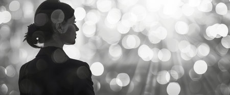 Silhouette of a beautiful woman in a black jacket. Blurred background.の素材