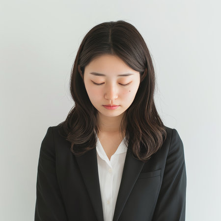Portrait of young business woman with closed eyes isolated on white background.の素材