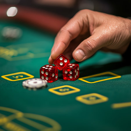 casino, gambling, poker, entertainment and people concept - close up of casino player with red dice and chips at green casino tableの素材