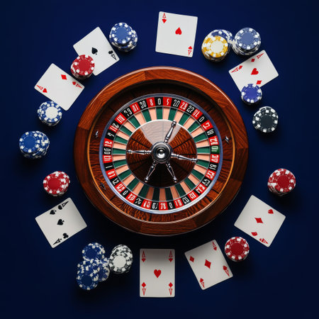 Casino roulette wheel with chips and cards on dark blue backgroundの素材