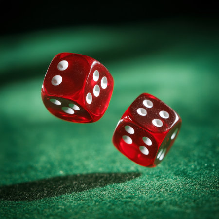 Two red dice on green background. Focus on the front dice.の素材