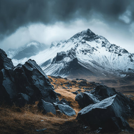 Beautiful mountain landscape with snow-capped peaks in the cloudsの素材
