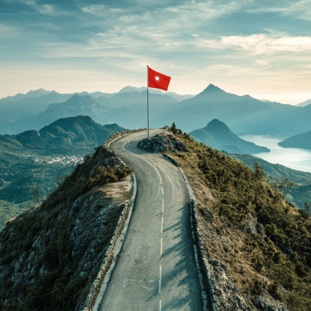 Road to the top of the mountain with red flag of Austria.の素材