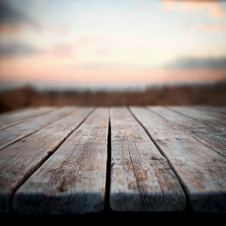 Wooden table in front of a sunset background. Selective focus.の素材