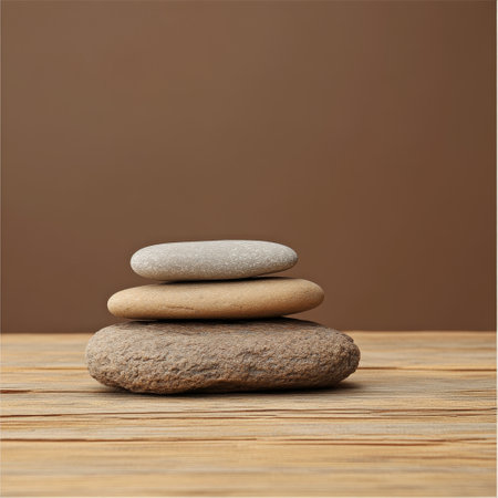 Stack of zen stones on wooden table over brown background. Zen conceptの素材
