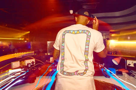 DJ with headphones at night club party under the lights nightout conceptの写真素材