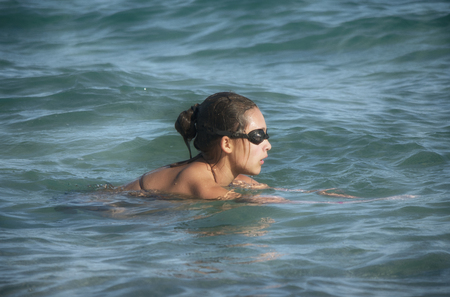 Pretty girl swims inside deep blue oceanの写真素材