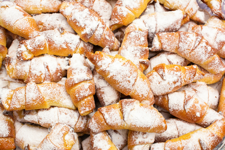 Fresh, delicious, sweet croissants with powdered sugar.の写真素材