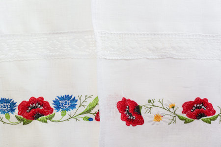 Embroidered floral pattern on a white linen towel