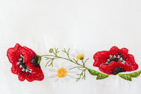 Embroidered floral pattern on a white linen towelの写真素材
