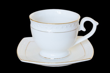 White porcelain cup with a saucer for tea or coffee, demitasse or teacup. Isolated, 

black background.の写真素材