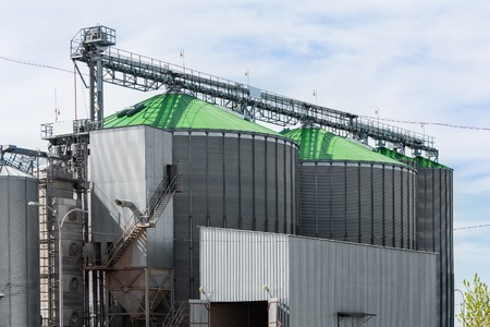 Grain elevator in agricultural zone. Granary with mechanical equipment for receiving, cleaning, drying, grain shipment.の写真素材