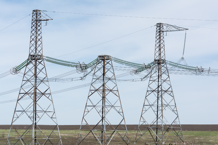 High-voltage power lines against the blue sky.の写真素材