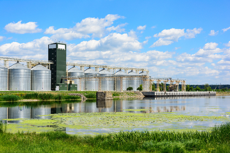 Grain elevator in agricultural zone. Granary with mechanical equipment for receiving, cleaning, drying, grain shipment.の写真素材