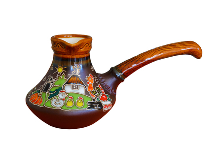 Traditional colored pottery, painted ceramic coffee pot. Isolated, white background.の写真素材