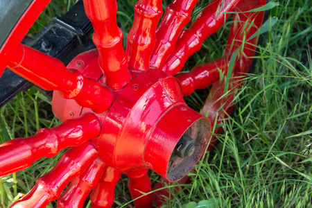 Red metal vintage wheel from the carriage close-up.の写真素材