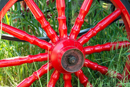 Red metal vintage wheel from the carriage close-up.の写真素材