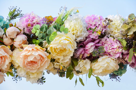 Decorative garland of artificial flowers - roses and hydrangeas.の写真素材