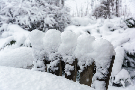 Winter, snowfall in the garden. Table and chairs covered with snow.の写真素材