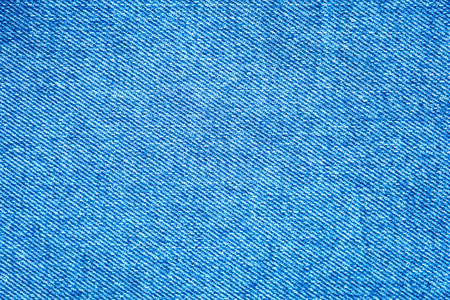 Texture of denim fabric. Blue jeans background, fragment of denim clothing.の写真素材