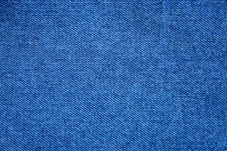 Texture of denim fabric. Blue jeans background, fragment of denim clothing.の写真素材