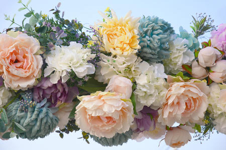 Decorative garland of artificial flowers - roses, hydrangeas and chrysanthemums.の写真素材