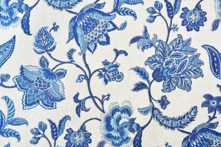 Blue ornate floral pattern on white cotton tablecloth.の写真素材