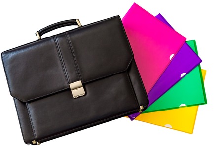 Black leather briefcase and colorful folding covers or holders for storing loose papers. Isolated, white background.の写真素材