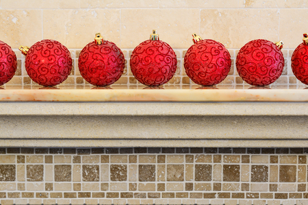 Christmas and New Year decorations: christmas red balls on the mantelpiece.の写真素材