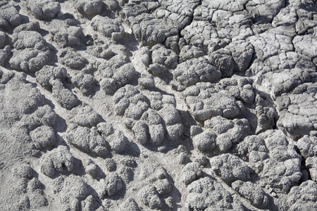Dry soil with deep cracks. Cracked mud surface. Texture of cracks on the ground.